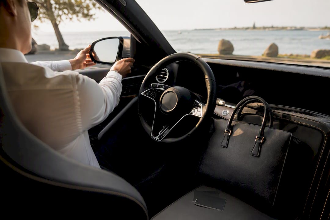 Hands unlocking luxury vehicle for Uber platform