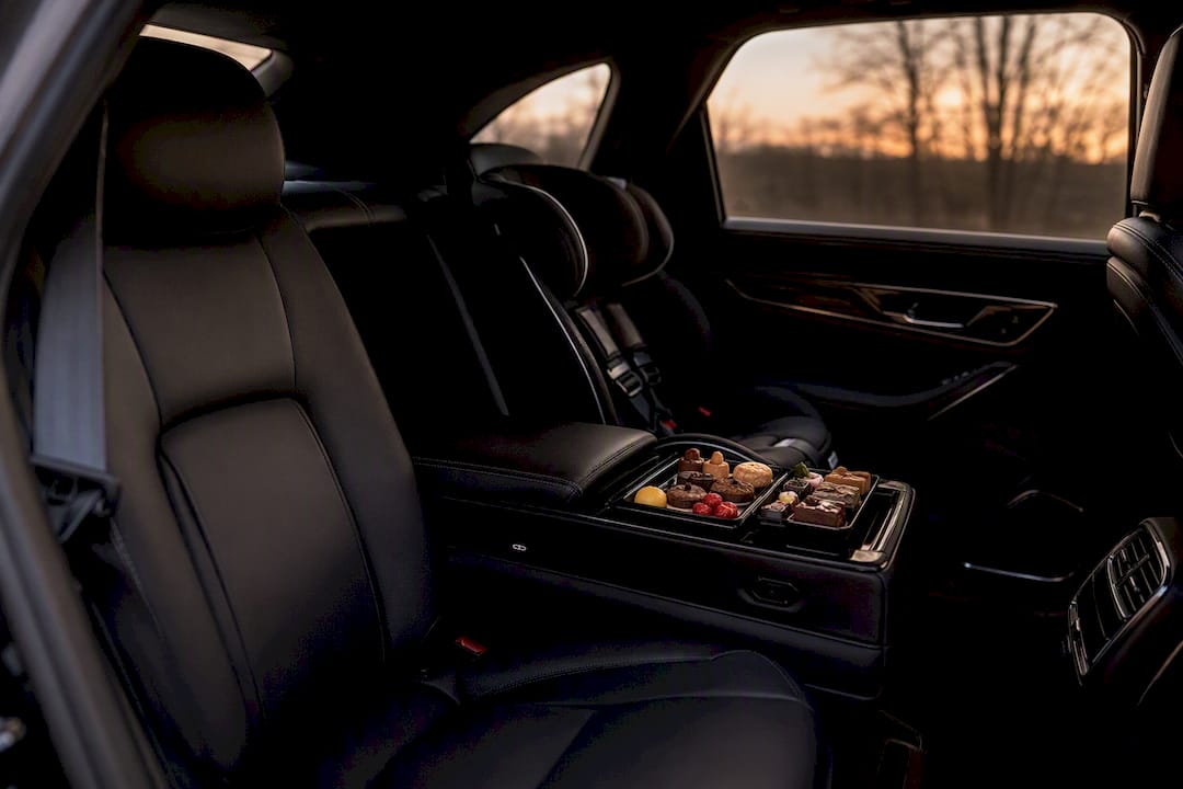 Luxury vehicle interior with child seat and amenities