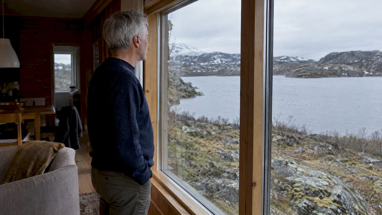 Traveler looking across remote northern private-home landscape